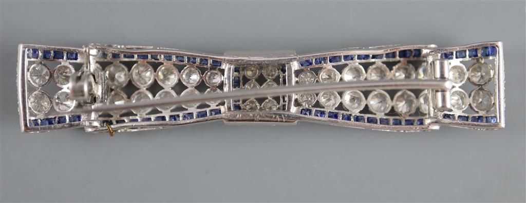 An Art Deco sapphire and diamond bow brooch mounted in white metal,